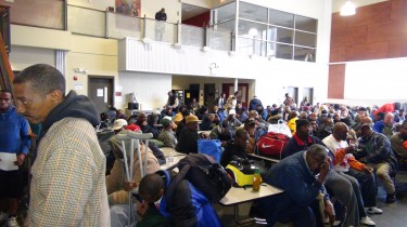 A Second group of homeless men wait their turn as the Atlanta City Mission Prepare them for intake for temporary shelter.  Photo by D. Garvin (c) 2014